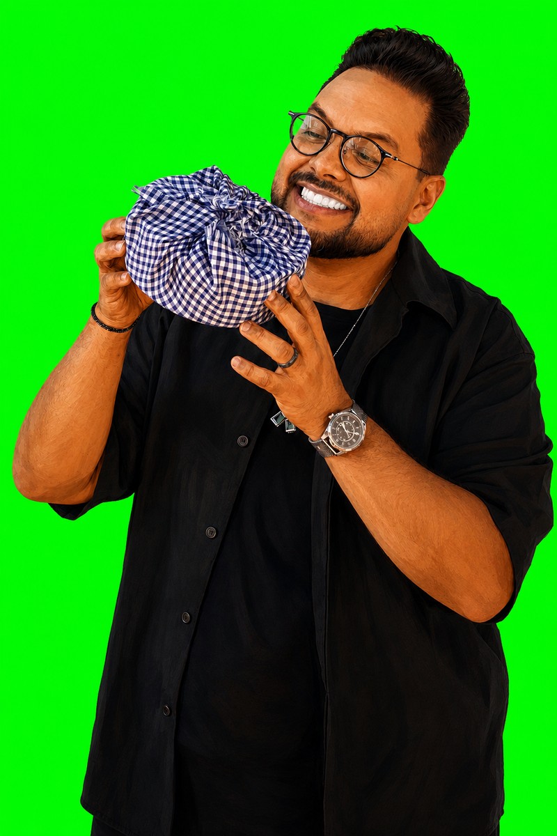 Renato holding a wrapped lunchbox against green